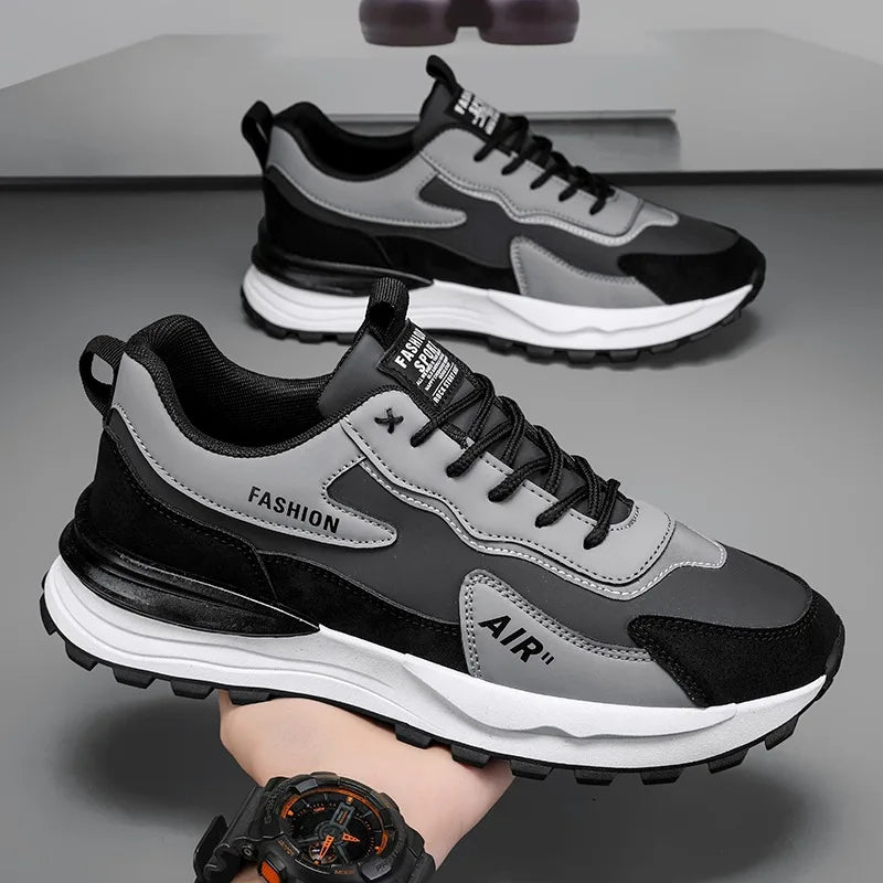 Tênis Casual Air Pro da Oron Store em fundo branco. Modelo unissex disponível nas cores branco e cinza, com cabedal em camurça e couro, e solado em borracha antiderrapante. Tênis casual com fechamento em cadarço, ideal para caminhadas, uso diário ou compor looks urbanos e confortáveis no verão 2025. Disponível nos tamanhos 37 ao 42.